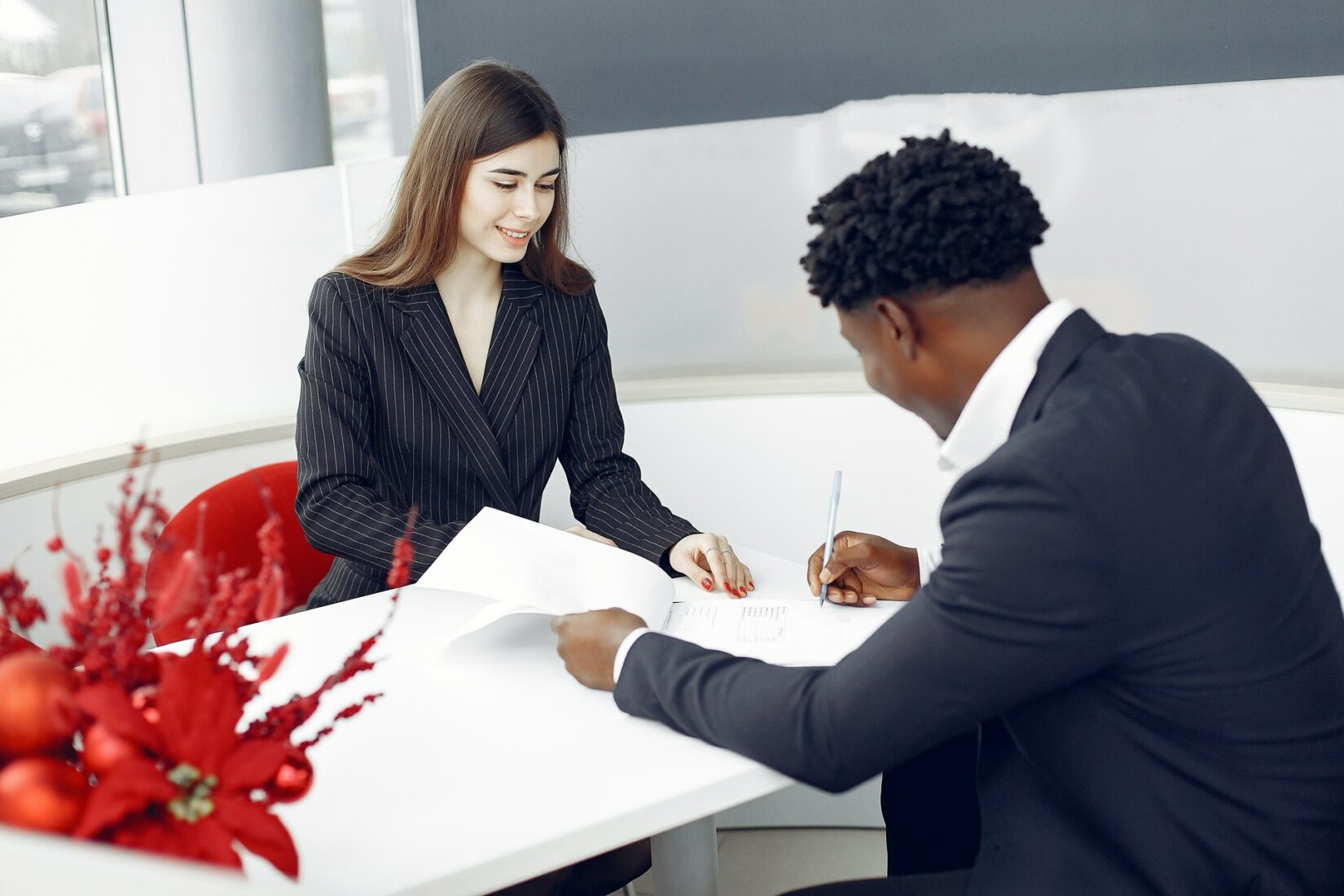 Two people in corporate attire having a discussion