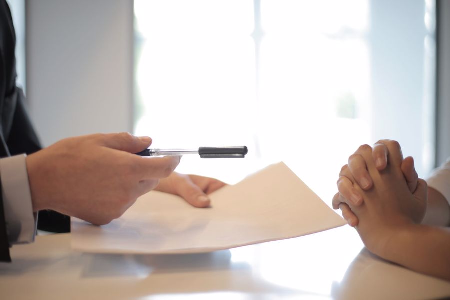 Man holding a paper and pen