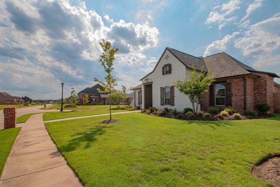 A house for sale with green front lawn