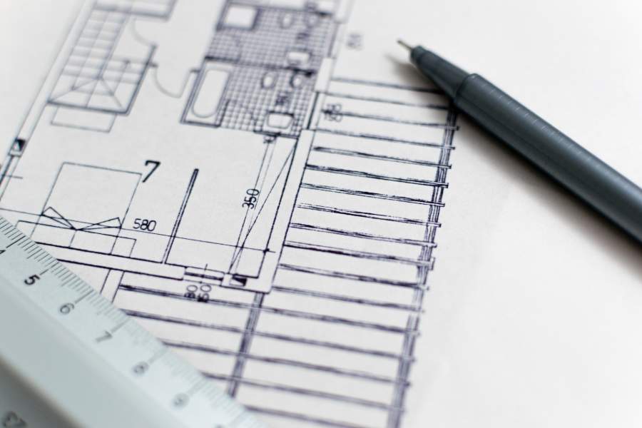 A black pen on top of a house floor plan