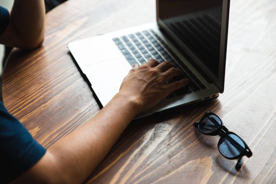 Person typing on a laptop keyboard