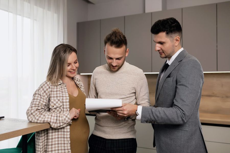 Couple signing the papers for their new home