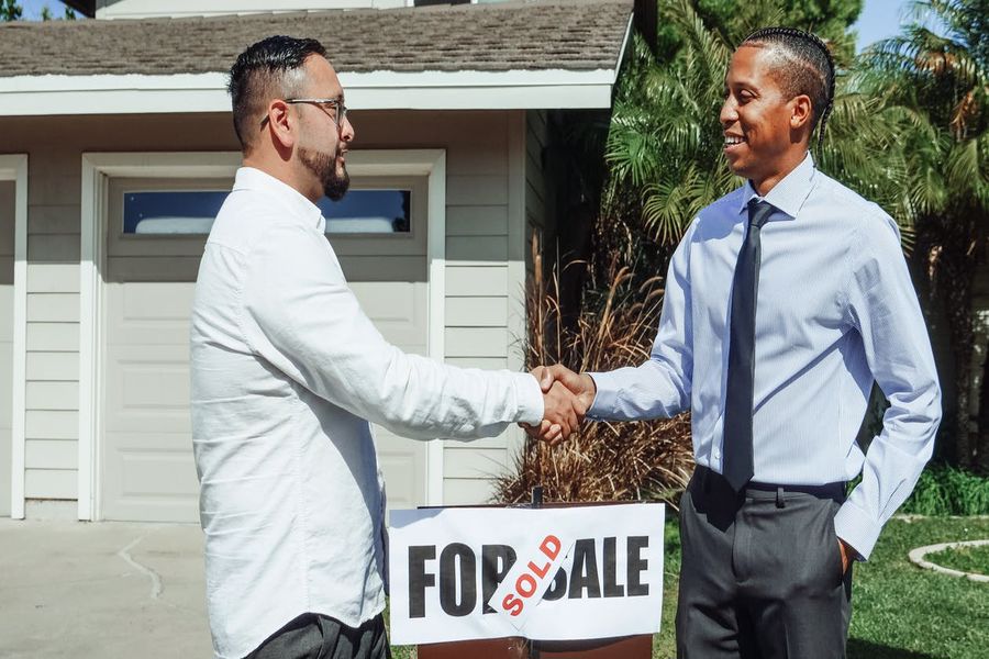 Realtor shaking hands with the new owner of a home