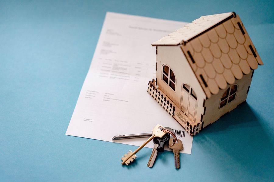 Miniature house and keys on top of a payment form