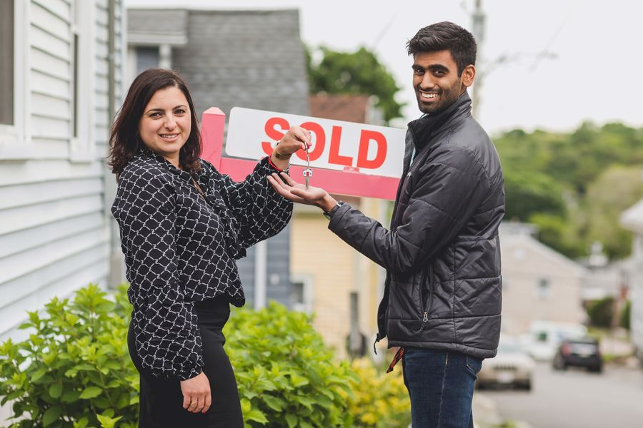 Realtor giving the keys to a purchased house to a buyer