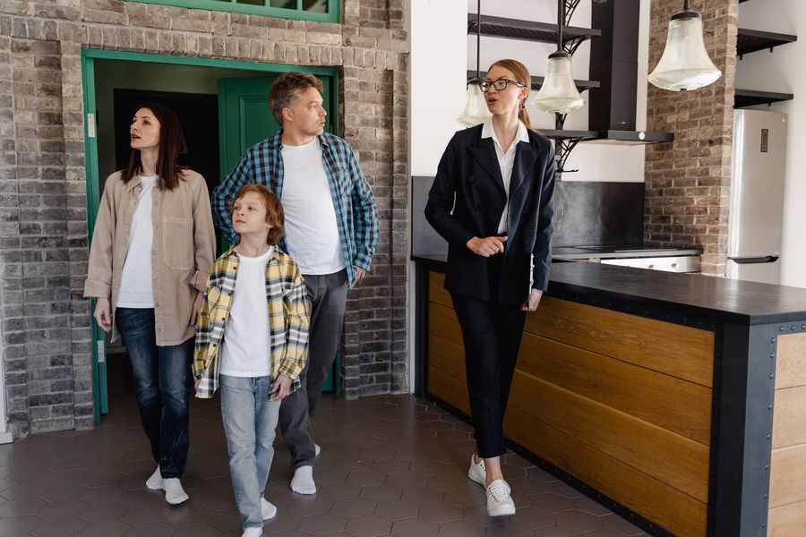 Real estate agent showing a property to a prospective family