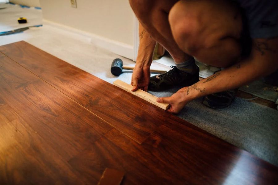 Man fixing their flooring