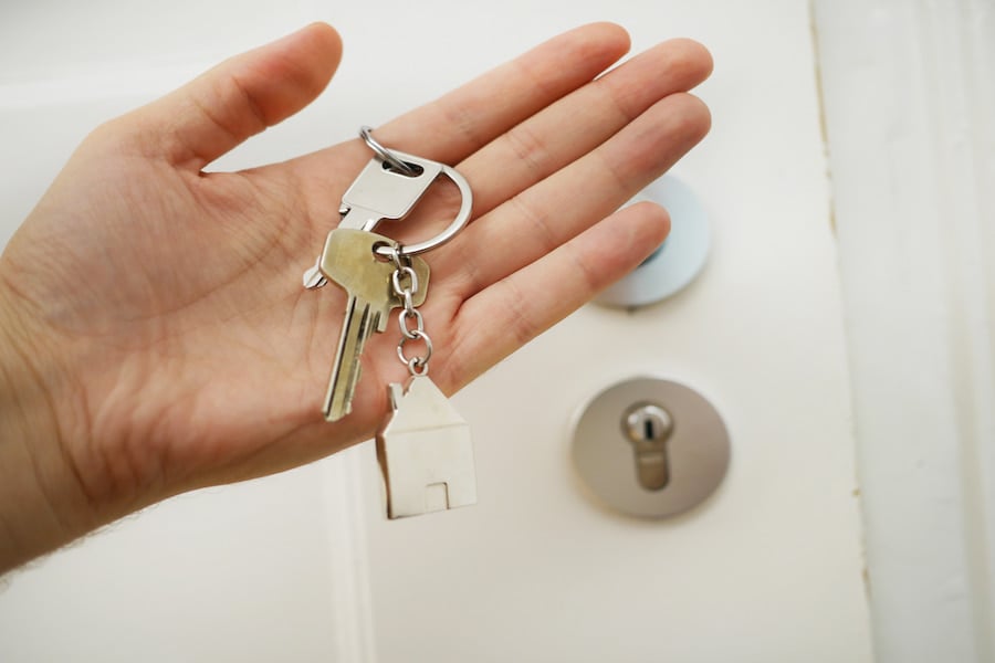 An image of a person's hand holding a set of keys