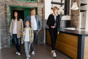 Real estate agent showing a property to a family