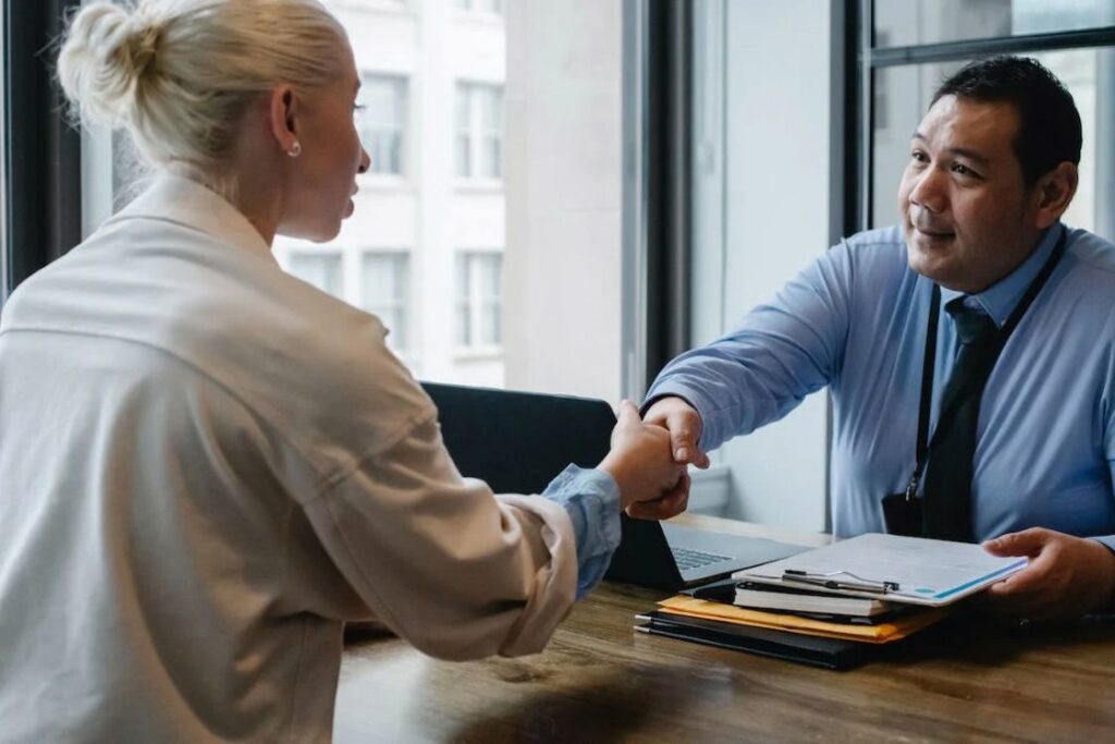 Woman shaking the hand of a real estate agent after a meeting