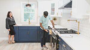 a person inspecting kitchen drawer in the presence of the homeowner